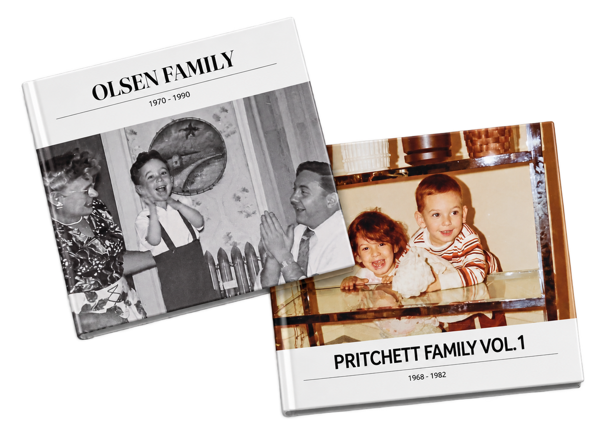 Two hardcover replica photo books with vintage family portraits on their covers