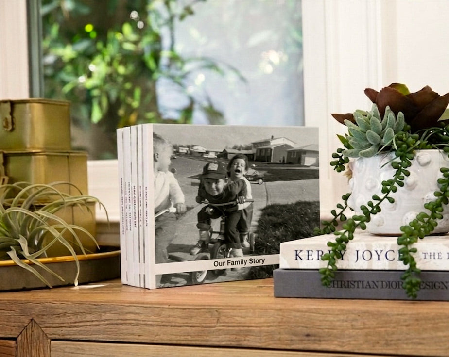 A stack of printed replica photo books displayed on a shelf
